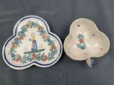 two ceramic dishes with designs on them are sitting on a table