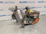 a close up of a chainsaw sitting on a table in front of a wall