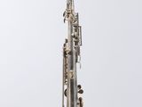 a silver plated clarinet with a black and white background