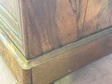 a wooden cabinet that is sitting on the floor