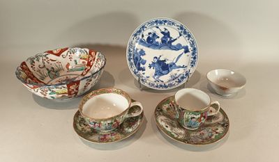 four cups and saucers sitting on a table next to each other