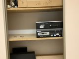 a shelf that has a dvd player and other items on it