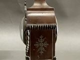 a small clock that has a bird on top of it