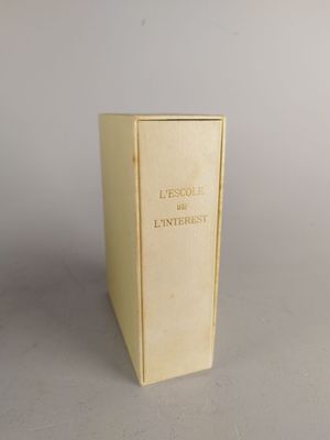 an old book sitting on top of a table next to a white wall