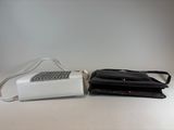 a white purse and a black purse on a white table