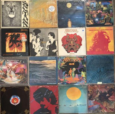 a lot of different album covers on the wall