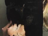 the cover of a magazine with a woman covered in black paint