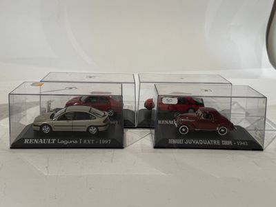 two model cars in clear boxes on a white surface