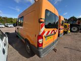 an orange van that is parked in a parking lot