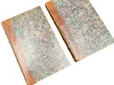 pair of antique leather bound books on a white background