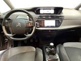 the interior of a car with a steering wheel and dashboard controls