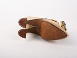 pair of brown leather shoes on white surface with white background