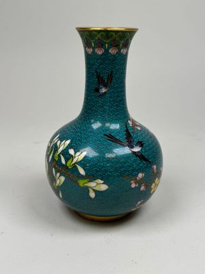a blue vase with birds and flowers painted on it