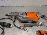 a drill that is sitting on a table next to other tools