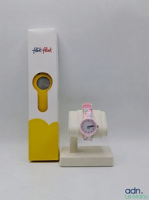 une montre posée sur un socle à côté d'une boîte