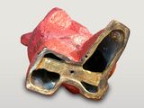 a red and gold object with a pair of glasses in it
