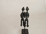 statue of a man and a woman on a wooden base