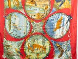 an image of a red scarf with a picture of animals on it