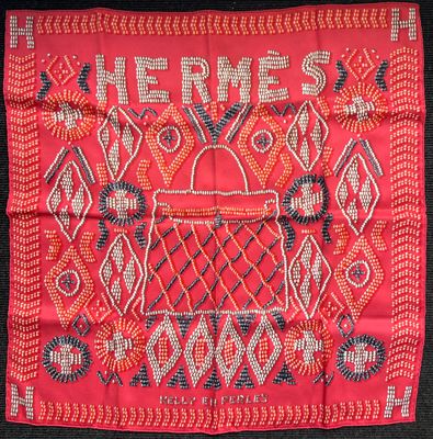 red and blue embroidered scarf with a purse and flowers on it