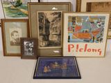 many framed pictures on a table with a picture of a man