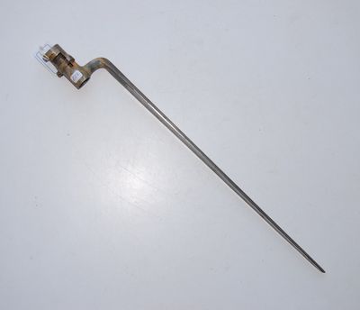 an old metal tool on a white surface with a white background