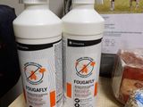 two bottles of sprays sitting on a table next to a bag