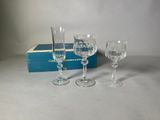 two wine glasses and a box of wine glasses sitting on a table