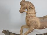 a wooden rocking horse that is sitting on a table