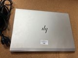 hp laptop with power cord and charger sitting on the floor