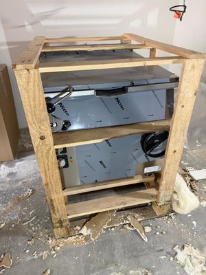 a picture of a wooden shelf with a metal device on top of it