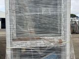 a broken window sitting on a pallet in a parking lot