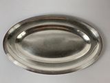 a silver plate on a table with a white background