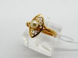 a close up of a gold ring with a pearl in it