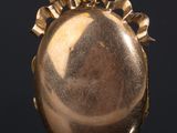 an image of a close up of a gold locke on a black surface