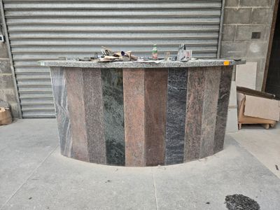 a marble bar on the sidewalk in front of a garage