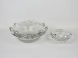 pair of clear glass ashtrays on a white background