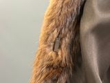 a close up of a jacket with a fur collar