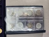 a lot of coins in a case on the table