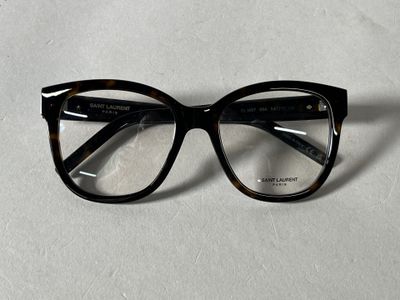 a pair of glasses sitting on a white surface