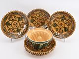 three bowls and a bowl on a stand with a bowl in front of them