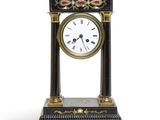 a black and gold clock sitting on top of a table