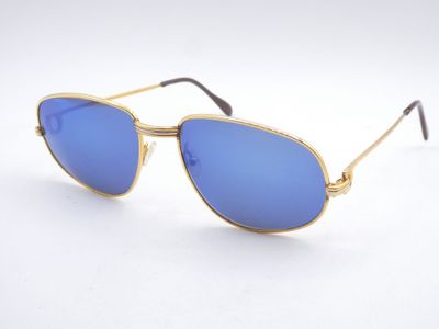 a close up of a pair of sunglasses on a white surface