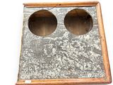 a wooden box with two holes in it on a white surface