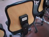 many chairs that are sitting in a row with a name tag attached to the back of them