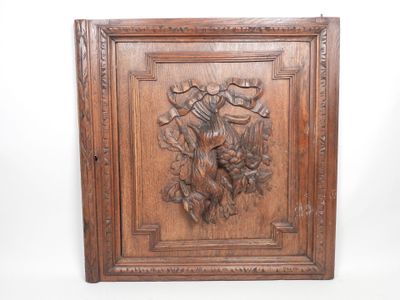 an old wooden plaque with a bird and flowers carved into it