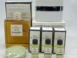 trois flacons de parfum et un porte-savon posés sur une table