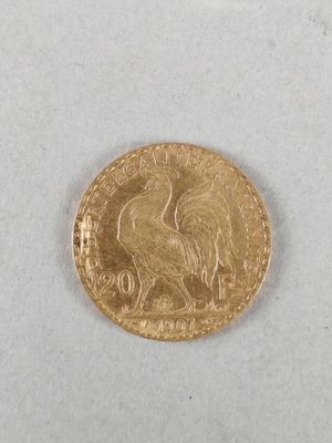 a close up of a gold coin on a white surface