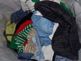 a pile of clothes in a basket on a bed