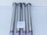 four different types of stainless steel pipes on a white surface