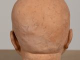 a clay head of a man on a table